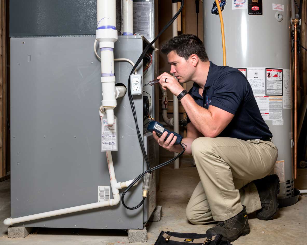 HVAC technician performing a furnace tune-up in Firestone